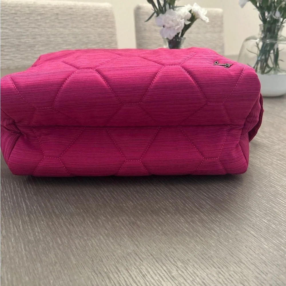 Lug Bumper purse in‎ a pink hue with a honeycomb quilting pattern